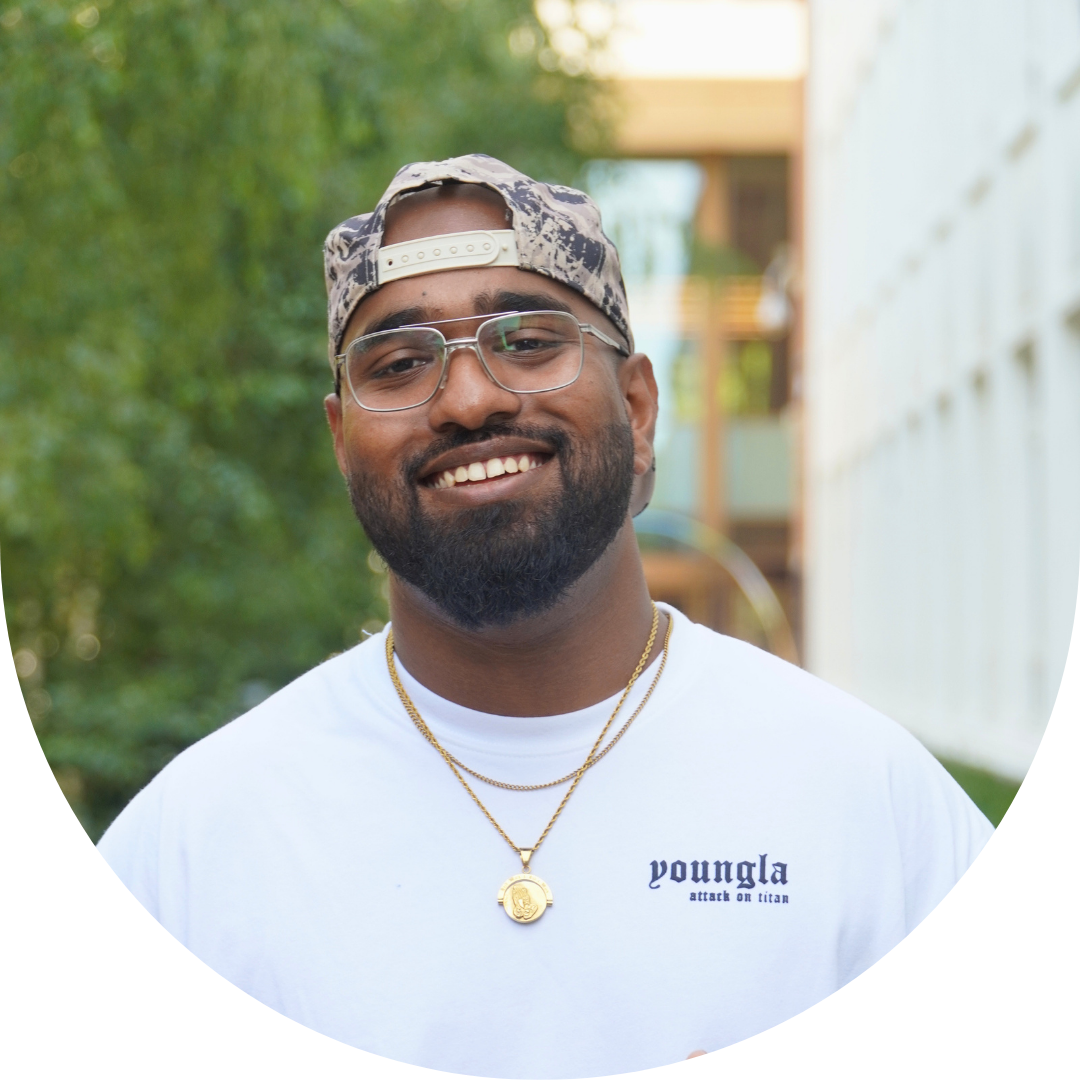 A person in white T-shirt with glasses smiling for a picture