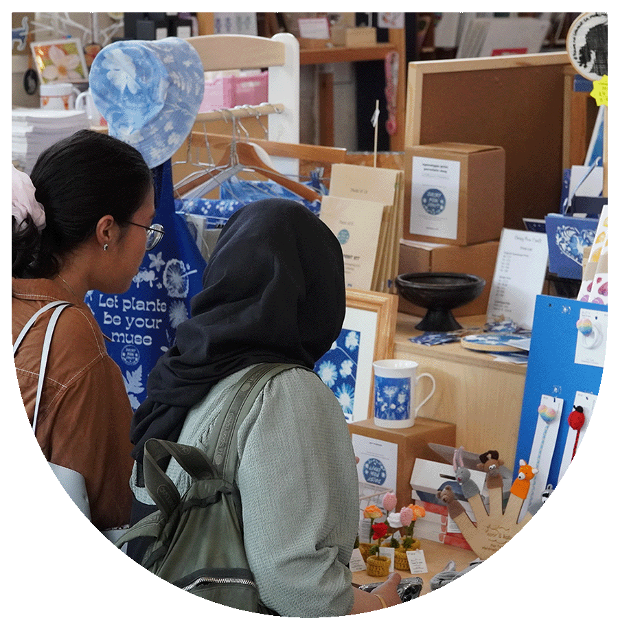 Two students looking at a market stall