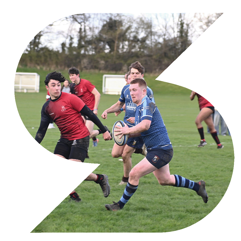 Group of students playing rugby on a grass pitch