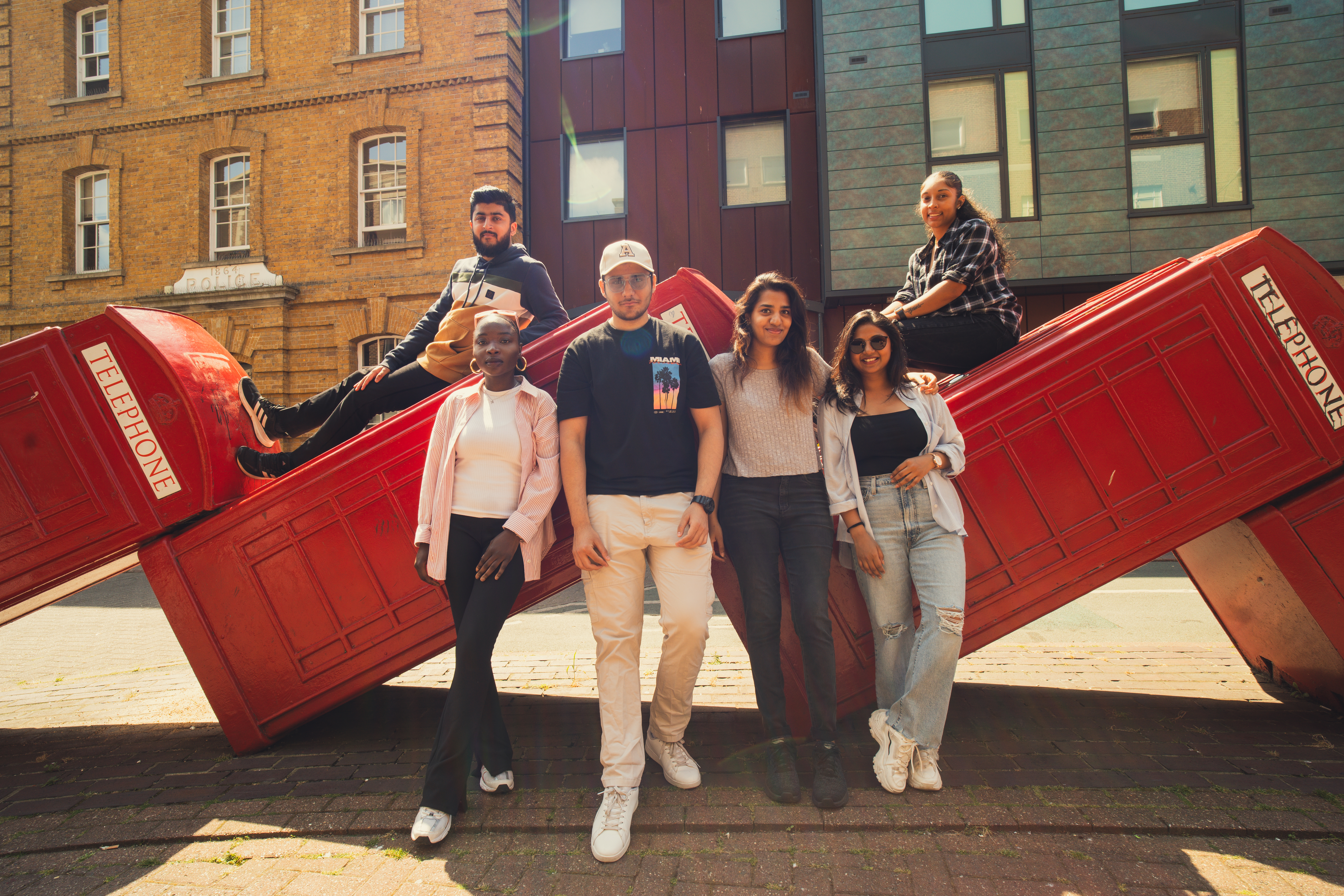 image of a group of students standing in front of phone booths