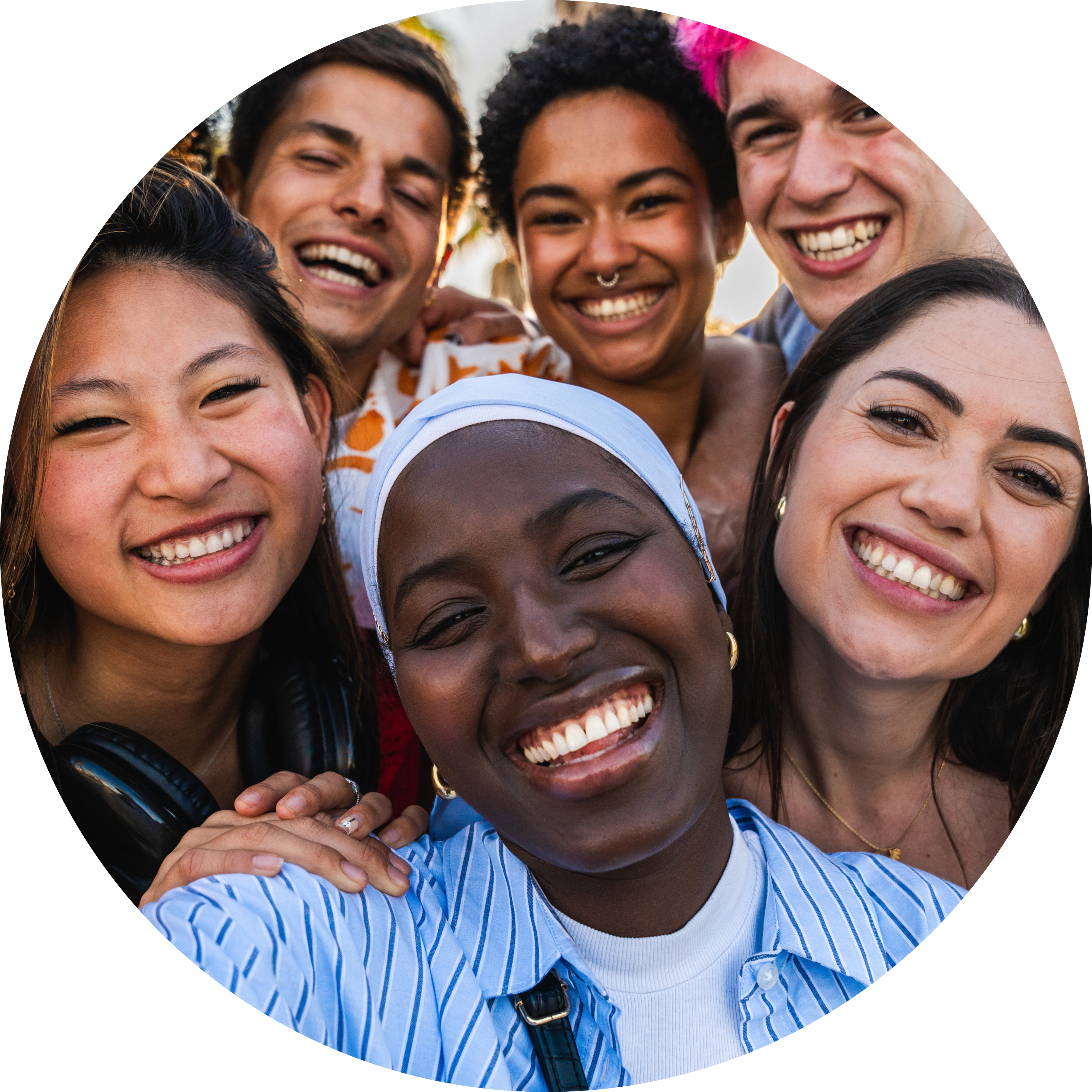 Diverse group of students wearing colourful clothing, putting their hands together and smiling at one another